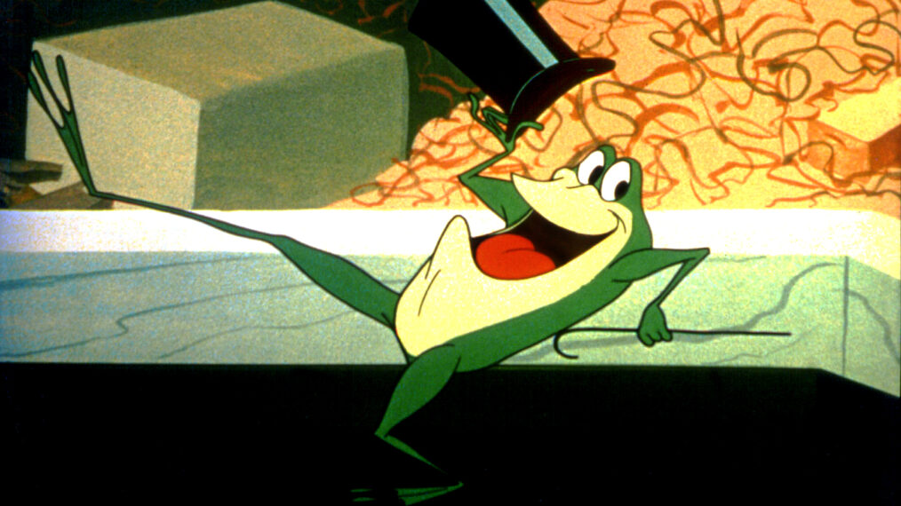 Michigan J. Frog, holding a cane and doffing a top hat while doing a high-kicking song-and-dance number, in the 1955 Merrie Melodies cartoon One Froggy Evening