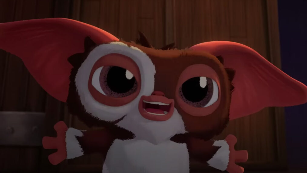 a closeup of Gizmo the Mogwai smiling with his arms wide open as if about to hug in a scene from the animated family series 