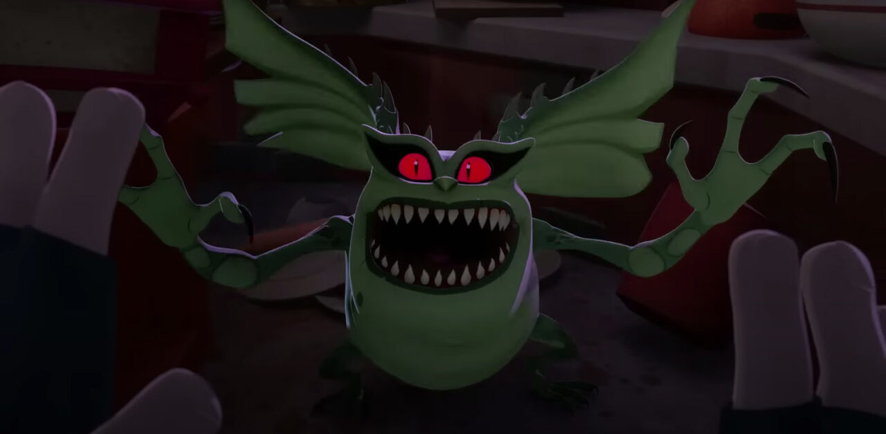 A transformed gremlin -- short, squat, green, with batlike ears and sharp claws -- reaches out as if leaping toward a character standing where the camera and viewers are, in a scene from the trailer for the series "Gremlins: Secrets of the Mogwai"