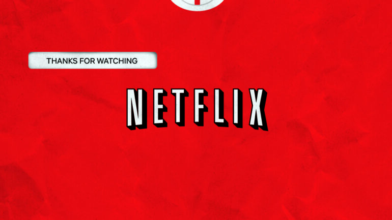 An extreme close-up of one of the iconic red envelopes Netflix uses to send DVDs to customers. Against the red background of the envelope is the Netflix logo in white. In the upper left, where a customer's address would normally be, instead is the phrase 