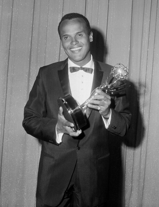 American actor, singer, and composer Harry Belafonte poses in front of a glittery curtain with the Emmy statue that he had just won for his CBS television musical special 'Tonight With Belafonte' at the 1960 Emmy Awards, June 20, 1960. Belafonte won for best entry a 'Variety/Musical Program/Series' and was the first African-American ever to win an Emmy. 