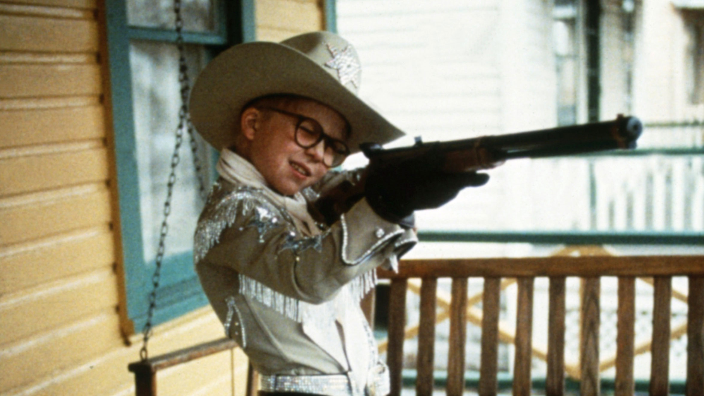 A Christmas Story house, Ralphie on porch with gun
