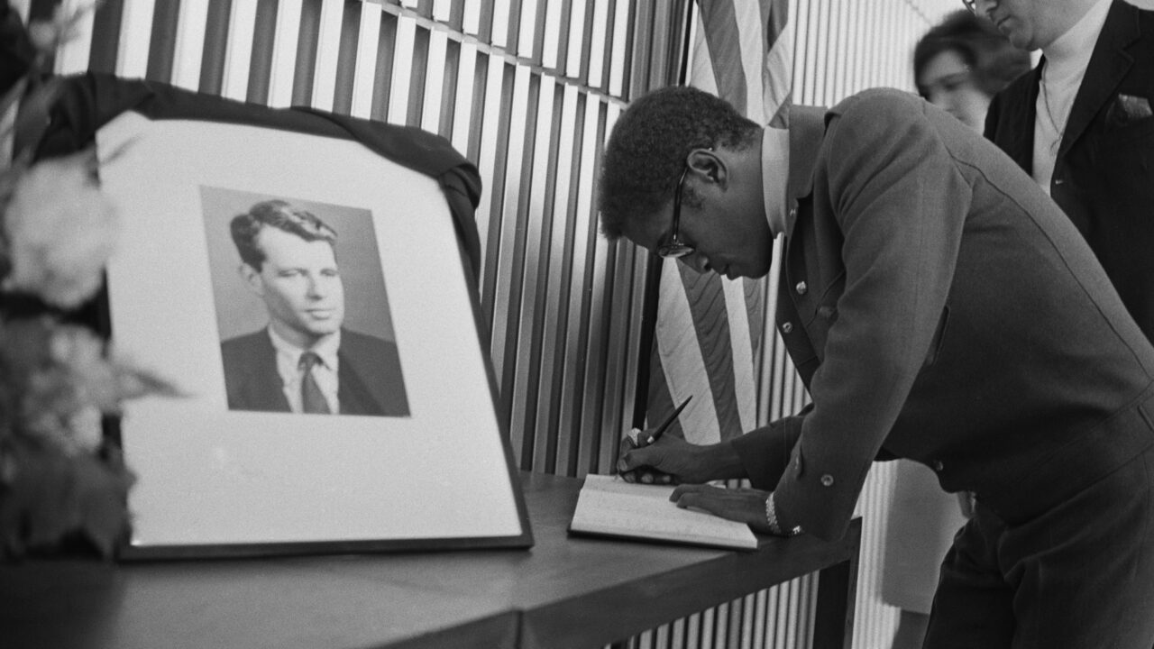 Sammy Davis Jr signing book for Robert Kennedy