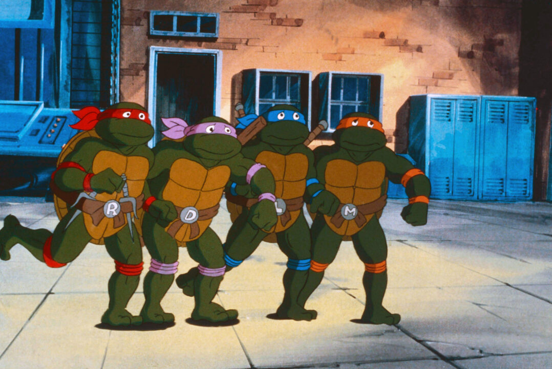 an image from the 1987-96 animated series "Teenage Mutant Ninja Turtles." Standing from left to right are the teen turtle characters Raphael (in a red mask), Donatello (purple mask), Leonardo (blue mask) and Michaelangelo (orange mask)