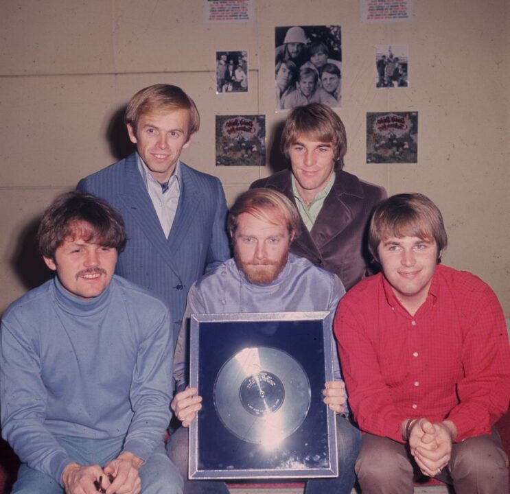DECEMBER 1967: The Beach Boys with their silver (platinum) disc. Clockwise from l to r; Bruce Johnston, Al Jardine, Mike Love (holding the disc)) Dennis Wilson(1944 - 1983) and bottom right, Carl Wilson (1946 - 1999). Best of The Beach Boys - vol1