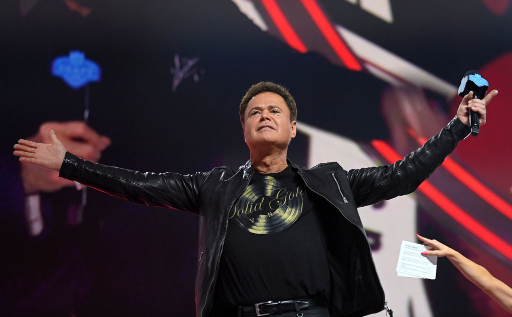 LAS VEGAS, NEVADA - APRIL 29: Entertainer Donny Osmond reacts onstage after the Las Vegas Raiders' 90th overall pick was announced during round three of the 2022 NFL Draft on April 29, 2022 in Las Vegas, Nevada