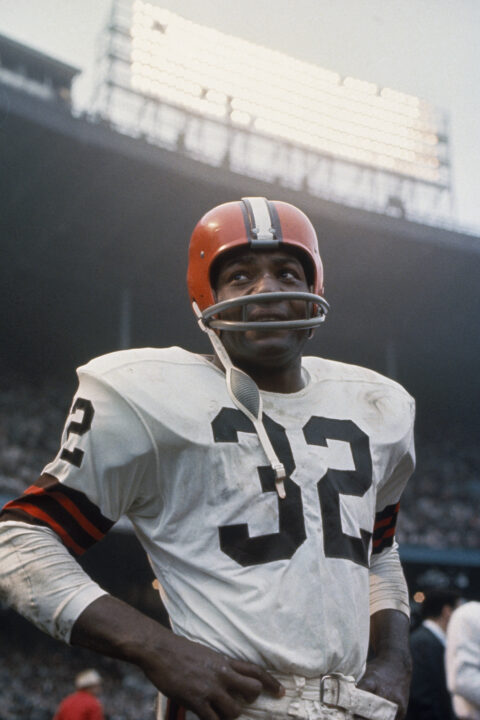 UNDATED: American football player, running back Jim Brown, #32 of the Cleveland Browns, stands on the field during a game. Jim Brown played for the Browns from 1957-1965.