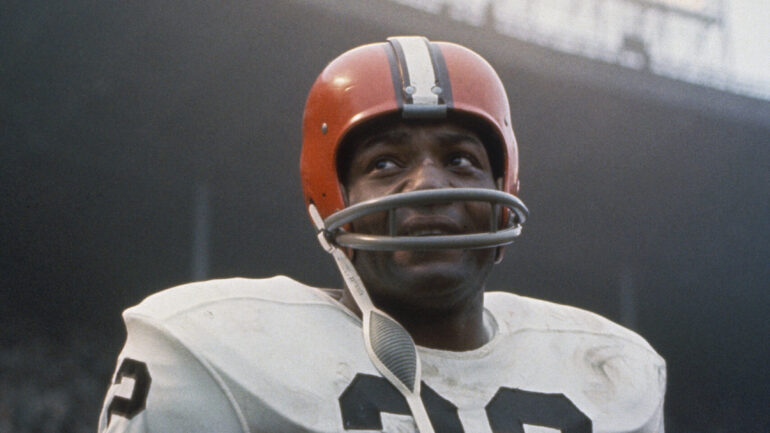 UNDATED: American football player, running back Jim Brown, #32 of the Cleveland Browns, stands on the field during a game. Jim Brown played for the Browns from 1957-1965.