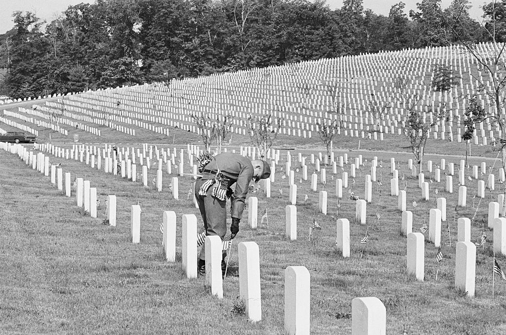 (Original Caption) Arlington, Va.: Small American flags are placed on the graves of America's war dead in Arlington National Cemetery in preparation for the observance of Memorial Day.