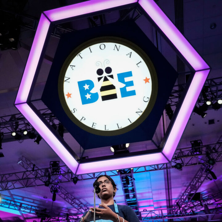 OXON HILL, MD - JUNE 2: 14-year-old Harini Logan from San Antonio, Texas uses her hand to write a word during the final round of the Scripps National Spelling Bee at the Gaylord National Harbor Resort on June 2, 2022 in Oxon Hill, Maryland. 234 spellers are competing in the first fully in-person Bee since 2019