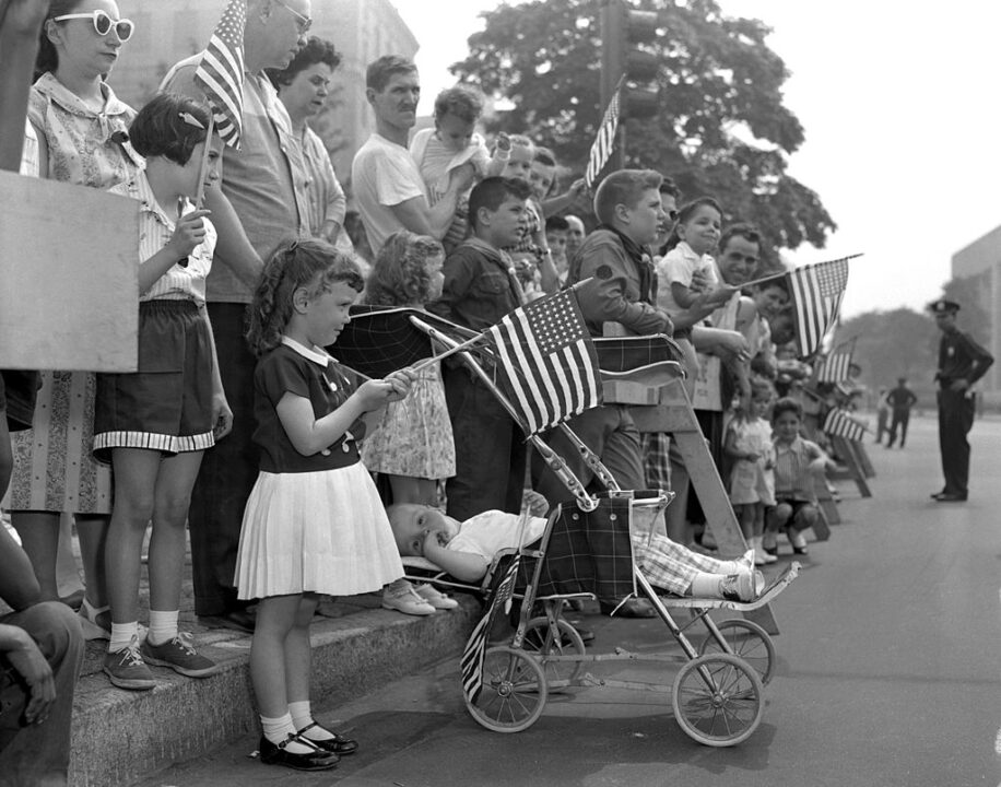 UNITED STATES - MAY 30: James Manico takes it easy in carriage as his sister, Gail (left), 4, watches the Memorial Day Parade on Eastern Parkway, Brooklyn