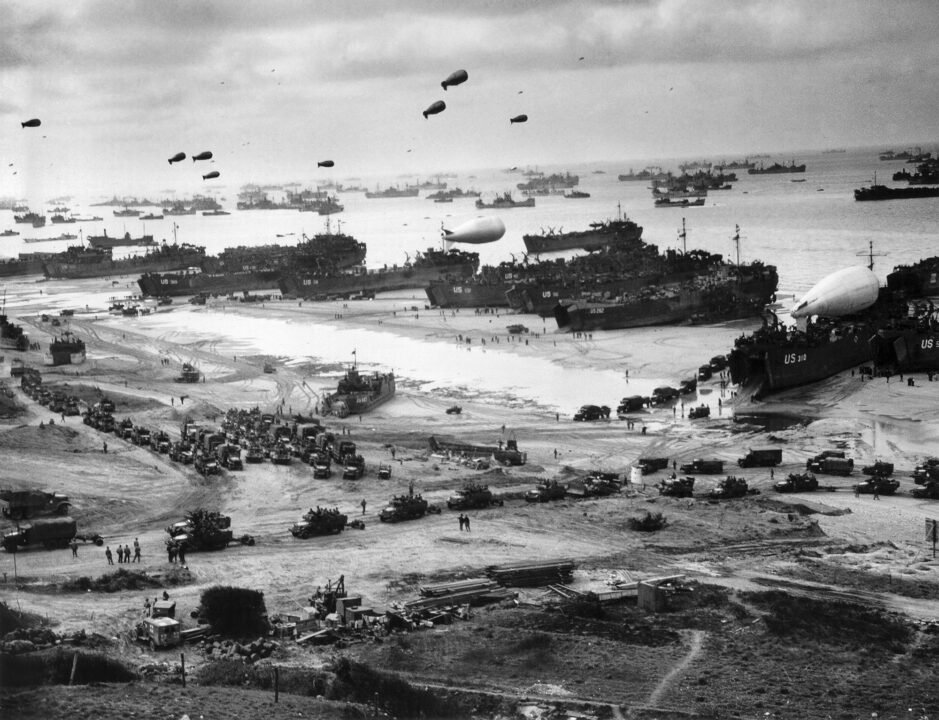 World War II photograph shows an aerial view of the various naval vessels around the beaches of Normandy in northernmost France. Shown here landing supplies such as tanks, military vehicles, weapons and troops; the Invasion of Normandy is considered the largest amphibious invasion in history.