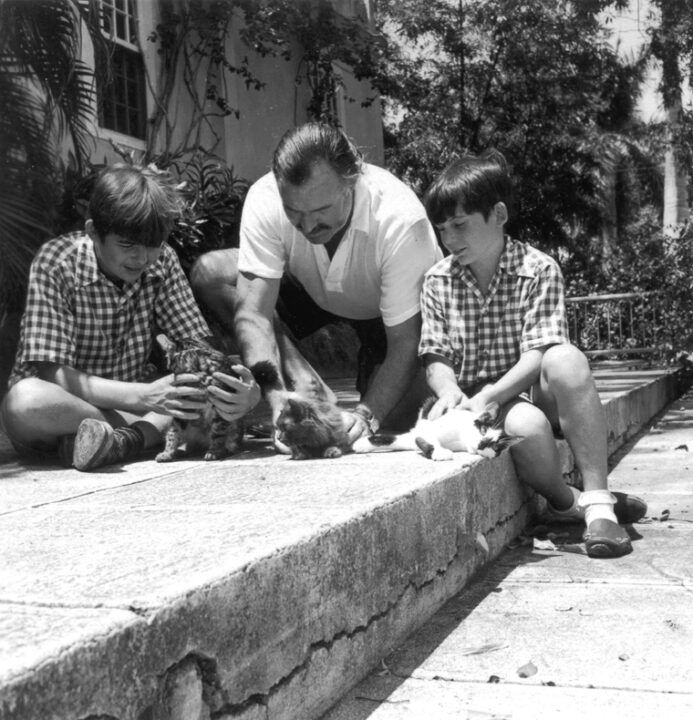 EH 2871P November 1946 Ernest Hemingway and sons Patrick (left) and Gregory, with cats Good Will, Princessa, and Boise. Finca Vigia (Hemingway home), San Francisco de Paula, Cuba. Photograph in the Ernest Hemingway 