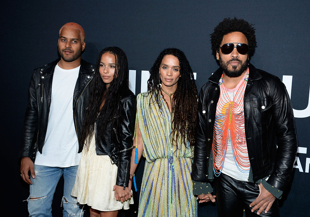 LOS ANGELES, CA - FEBRUARY 10: (L-R) Recording artist Twin Shadow, actors Zoe Kravitz, in Saint Laurent by Hedi Slimane, Lisa Bonet and recording artist Lenny Kravitz attend the Saint Laurent show at The Hollywood Palladium on February 10, 2016 in Los Angeles, California.