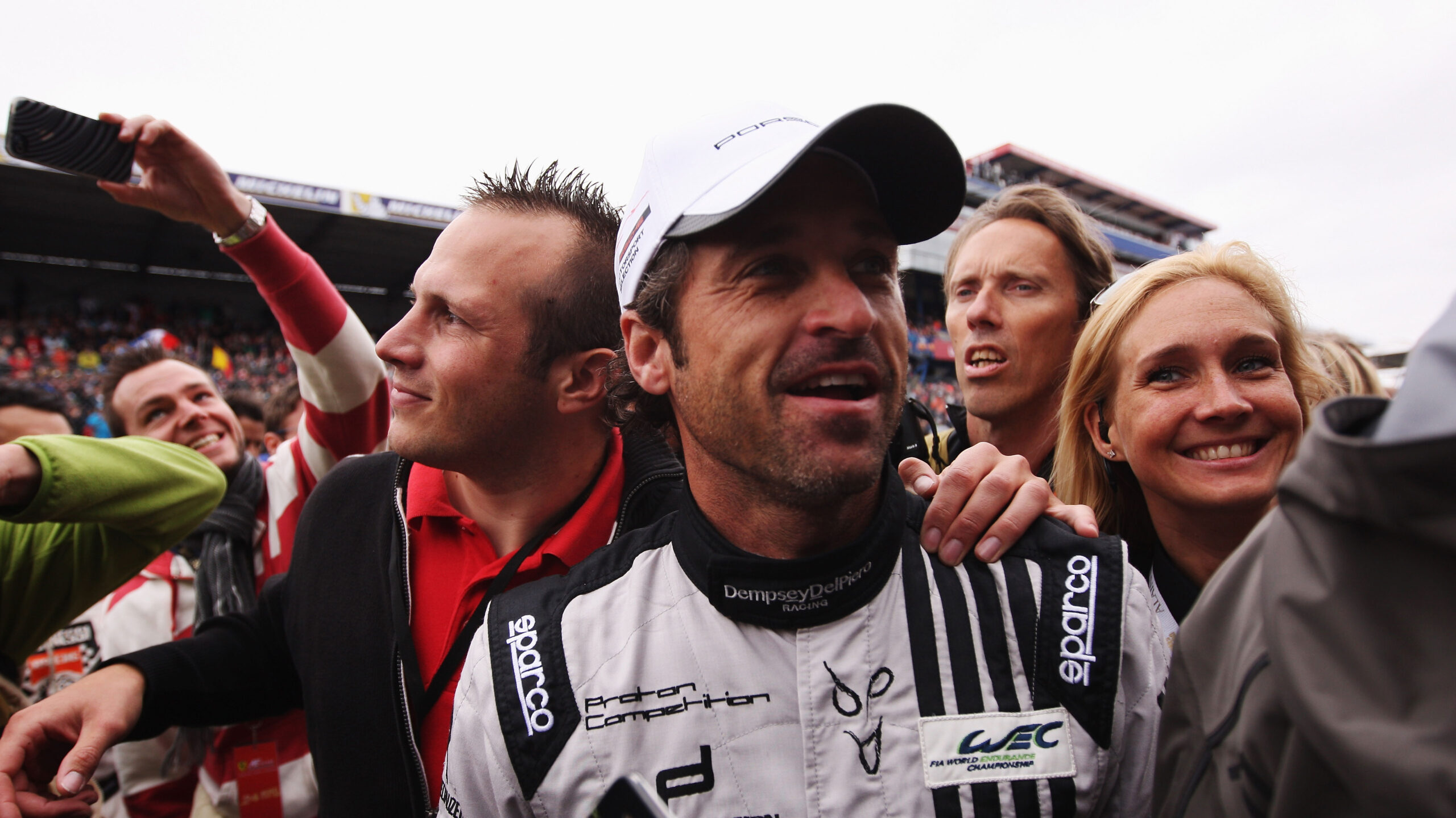 Actor Patrick Dempsey of the Dempsey Del Piero-Proton team is surrounded by media and well wishers on the grid before the Le Mans 24 Hour race at the Circuit de la Sarthe on June 22, 2013 in Le Mans, France.