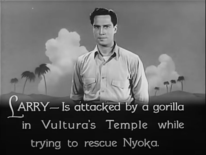 black and white still from the 1942 movie serial "Perils of Nyoka." It is an opening title card catching the audience up to where the serial is currently at as it enters Chapter Two. Beneath a picture of the film's male hero, Larry (Clayton Moore, dressed in a white explorer/archaeologist shirt) is text recapping how the first chapter ended on a cliffhanger. It reads: "Larry is attacked by a gorilla in Vultura's Temple while trying to rescue Nyoka."
