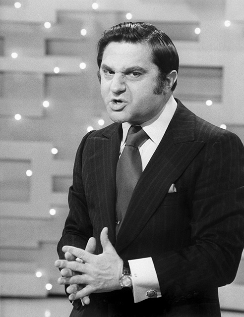 a black-and-white image from the final episode of "The Ed Sullivan Show," which aired March 28, 1971. It shows impressionist David Frye doing an impersonation of then-President Richard Nixon, contorting his face in a Nixon-like manner.
