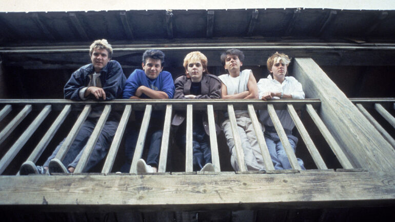 British pop group Duran Duran looking down from a balcony, c. 1983. L-R: Singer Simon Le Bon, bassist Andy Taylor, keyboardist Nick Rhodes, drummer Roger Taylor and bassist John Taylor