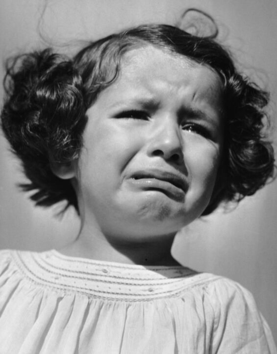 UNITED STATES - CIRCA 1950s: Portrait of young girl crying. 