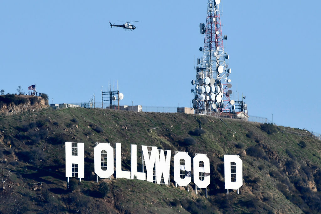 The famous Hollywood sign reads "Hollyweed" after it was vandalized, January 1, 2017. - Police said unidentified thrill-seekers had climbed up and arranged tarps over the two letter "O's" to make them look like "E's," CBS affiliate KCAL reported. Each letter is 45 feet (13.7 meters) high, so the feat would have required not just bravado but considerable athleticism