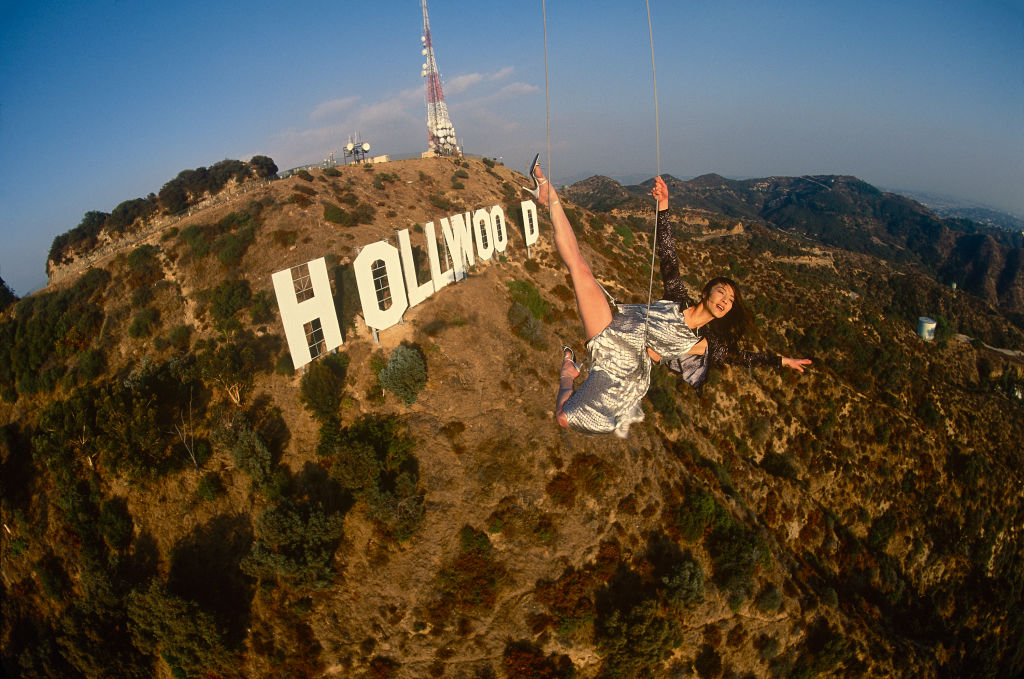 Actress Michelle Yeoh in mid-air over the famous Hollywood sign in November 1998 in Los Angeles, California