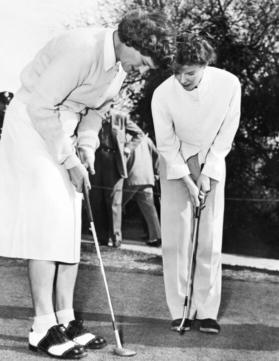 (Original Caption) Babe Didrikson, foremost woman golfer, has a tip or two for Katharine Hepburn (R). But Katharine, ready to be shown, is herself remembered as a one-time finalist in the Connecticut Women's Golf Tournament. Photo filed 5/25/1952.