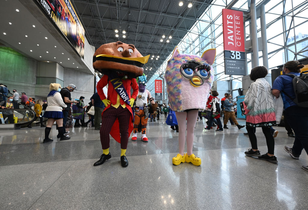NEW YORK, NEW YORK - OCTOBER 09: Cosplayers dressed as Mayor McCheese and Furby during Day 3 of New York Comic Con 2021 at Jacob Javits Center on October 09, 2021 in New York City