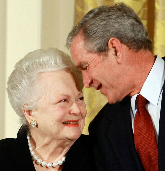 WASHINGTON - NOVEMBER 17: U.S. President George W. Bush congratulates actress Olivia de Havilland before presenting her with the 2008 National Medals of Arts award during an event in the East Room at the White House November 17, 2008 in Washington, DC. During the event president Bush presented recipients with awards for the National Medals of Arts and the National Humanities Medal. 
