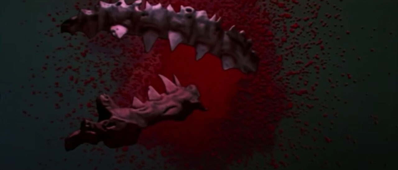 shot from the climax of "Jaws 3." The shark has been exploded by a grenade, and floating toward the screen (the shot was originally presented in 3-D), amid a cloud of blood, are parts of the shark's innards and its jaws.
