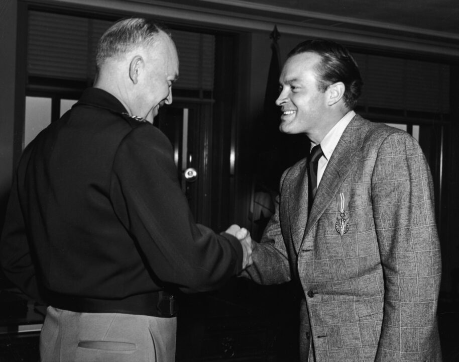 British-born actor and comedian Bob Hope shakes hands with General Dwight D. Eisenhower after receiving a Medal of Merit for his work as a USO entertainer overseas, Washington, DC, October 24, 1946. 