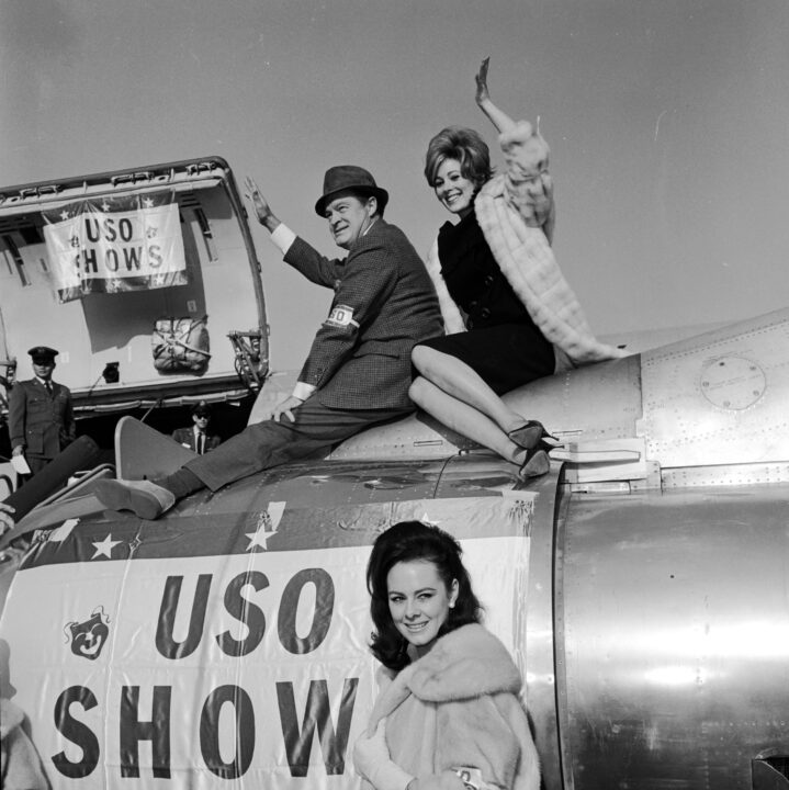 1964: US comedian Bob Hope (1903 - 2003) with Jill St John and Ann Sidney, stars of his Christmas show for US troops stationed in the Far East.