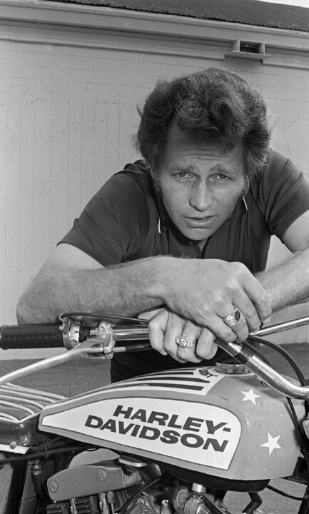 Mar. 3, 1972: Evel Knievel poses next to his Harley-Davidson motorcycle before his jump over 15 cars at the Cow Palace. 