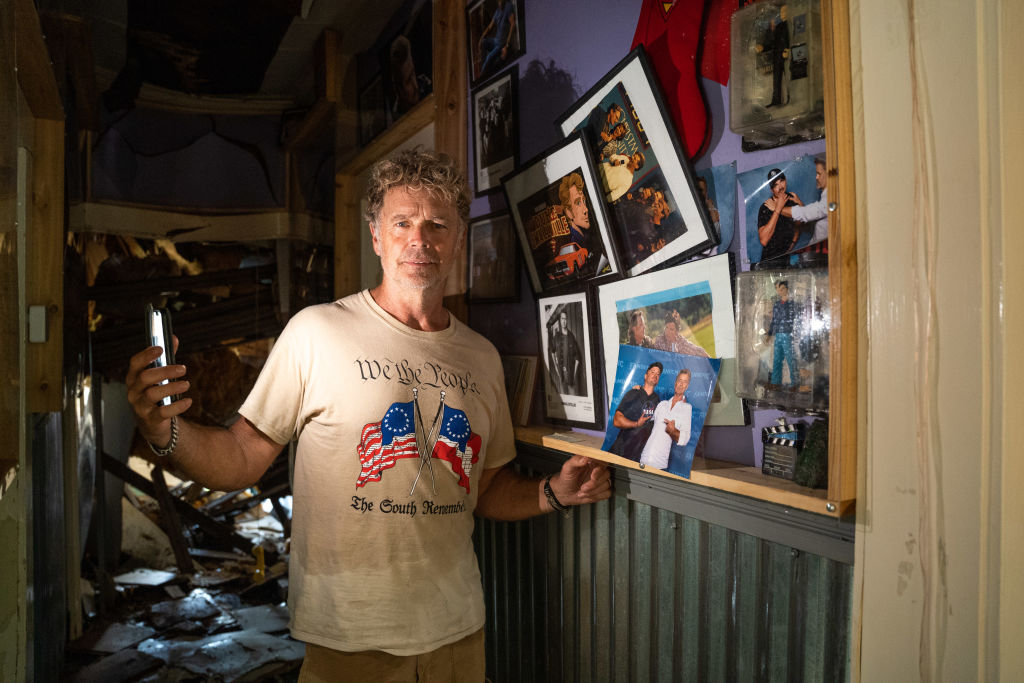 HOLDEN, LA - SEPTEMBER 2: Actor John Schneider, known for his role as Bo Duke in "The Dukes of Hazzard" television series, stands inside his studio that was damaged by Hurricane Ida on September 2, 2021 in Holden, Louisiana. Ida made landfall as a Category 4 hurricane Sunday in Louisiana, bringing flooding, wind damage and power outages along the Gulf Coast