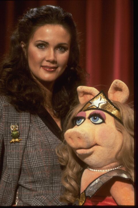 Wonder Woman actress Lynda Carter with Miss Piggy (dressed as 'Wonder Pig') on the set of The Muppet Show at Elstree Studios, Hertfordshire, circa 1980. 