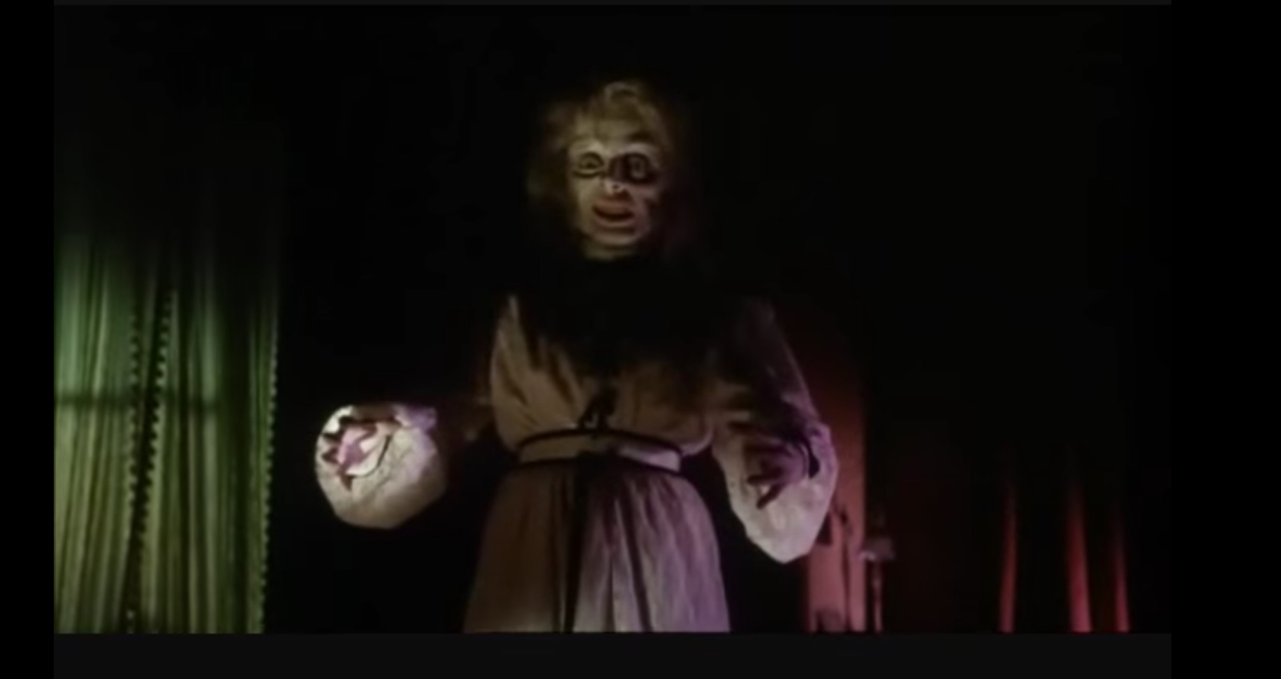 scene from the 1963 horror film "Black Sabbath." It depicts a walking corpse, its face wrinkled, eyes widened and with a sinister grin on its face, walking with outstretched arms toward an unseen victim. It is the corpse of a woman wearing an early 20th century dressing gown in which she died, and is now back for revenge on the woman who stole the ring off her finger.