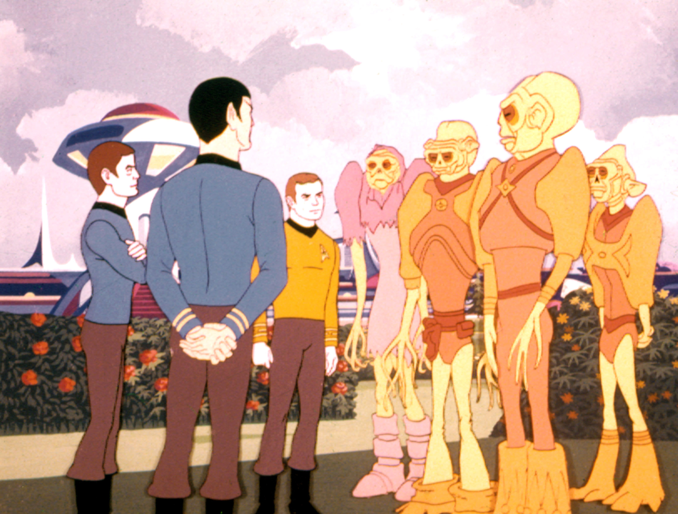 image from the 1973-74 show "Star Trek: The Animated Series." It depicts animated versions of Captain Kirk, Spock and Dr. McCoy meeting with a group of aliens.