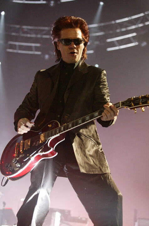 LONDON - APRIL 13: Andy Taylor of Duran Duran performs on stage during the first London date of their UK tour at Wembley Arena on April 13, 2004 in London. The original band members played their first shows in 18 years last year in celebration of the band's 25th anniversary