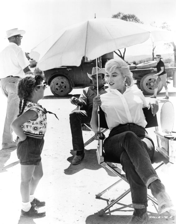 A young fan approaches MONTGOMERY CLIFT and MARILYN MONROE on-location for THE MISFITS, 1961