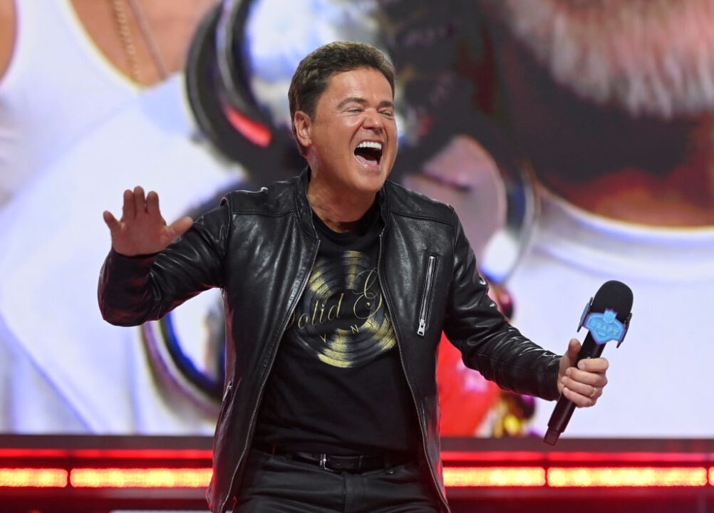 LAS VEGAS, NEVADA - APRIL 29: Entertainer Donny Osmond laughs onstage after the Las Vegas Raiders' 90th overall pick was announced during round three of the 2022 NFL Draft on April 29, 2022 in Las Vegas, Nevada