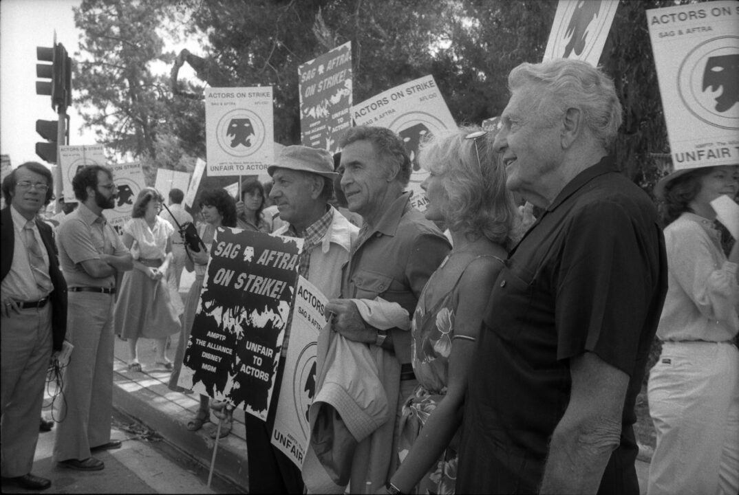 Jack Klugman, Ricardo Montalbán, Loretta Swit and Ralph Bellamy standing among the picketers