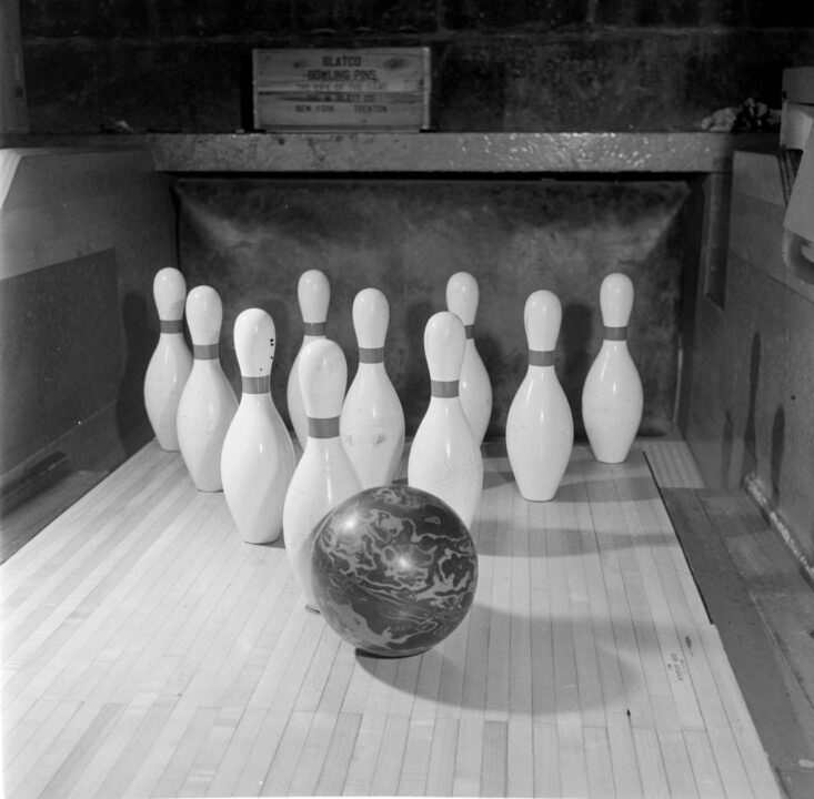 circa 1950: A bowler from Jamaica High School, New York, about to score a strike by knocking all ten wooden pins down with one roll of the ball