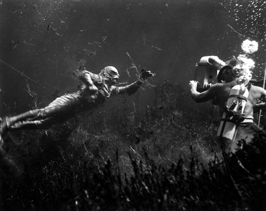 CREATURE FROM THE BLACK LAGOON, shooting underwater scene: Ricou Browning (on left, as 'The Creature'), cameraman Scotty Welbourne (on right, credited as 'Charles S. Welbourne'), 1954.
