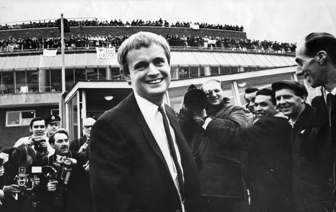 British actor David McCallum at London airport surrounded by photographers and fans.