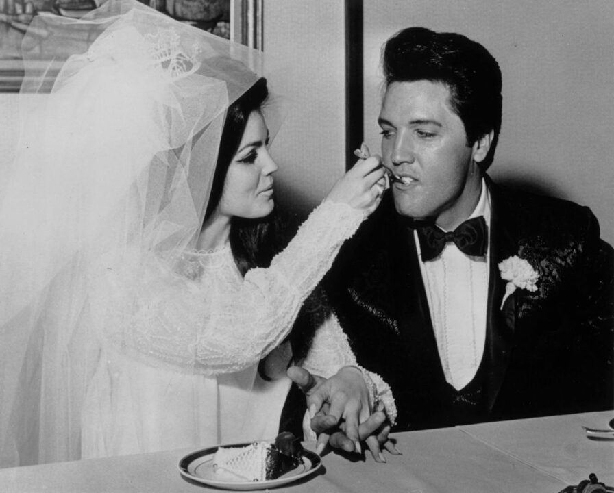 Elvis Presley (1935 - 1977) being fed a mouthful of wedding cake by his bride Priscilla Beaulieu at the Aladdin Hotel, Las Vegas