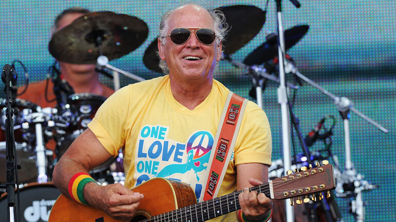 GULF SHORES, AL - JULY 11: Musician Jimmy Buffett performs onstage at Jimmy Buffett & Friends: Live from the Gulf Coast, a concert presented by CMT at on the beach on July 11, 2010 in Gulf Shores, Alabama