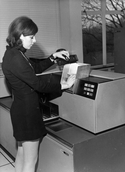 30th January 1970: Loading cards into the hopper of an IBM 1442 Card Read Punch. This unit is used as an input-output device with an IBM System 360 computer