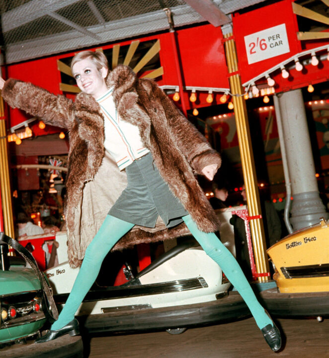 Twiggy, the model, holding onto a pole of a dodgem car at Bertram Mills Circus, Olympia