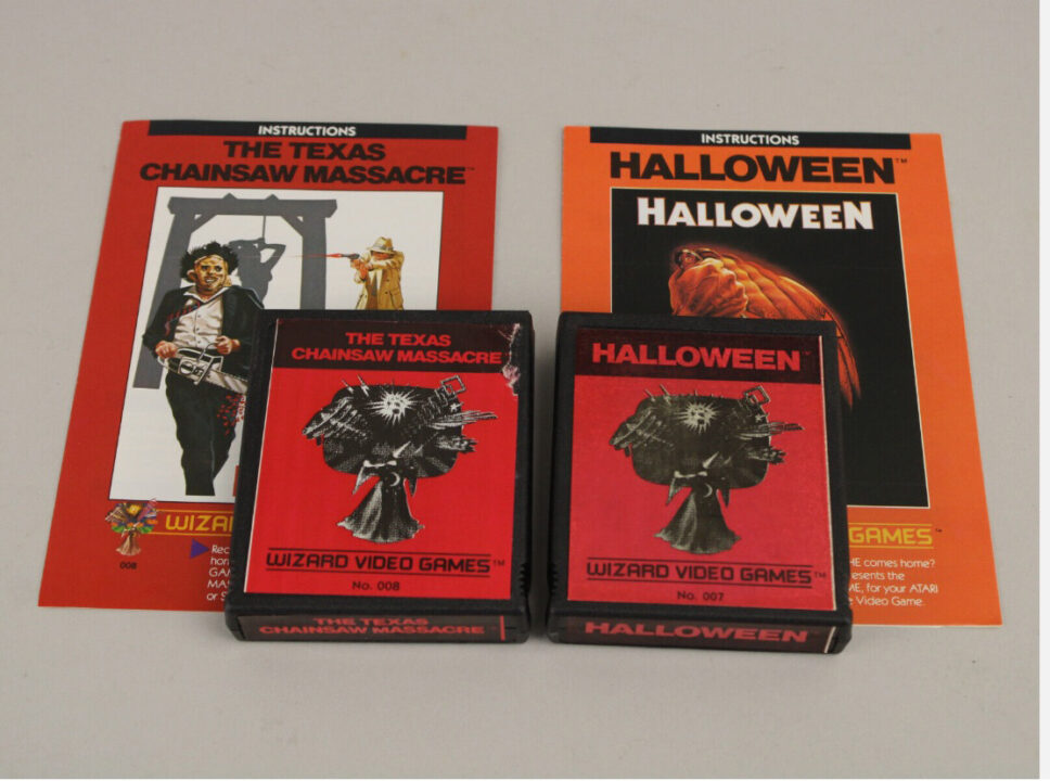 image from an eBay sale for the 1983 Atari 2600 video games "Halloween" and "The Texas Chainsaw Massacre." the image has both games' cartridges and their instruction manuals.