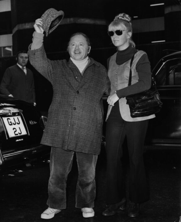 Actor Mickey Rooney doffing his hat as he arrives from Miami with his wife Carolyn Hockett, at London Airport, December 10th 1971.