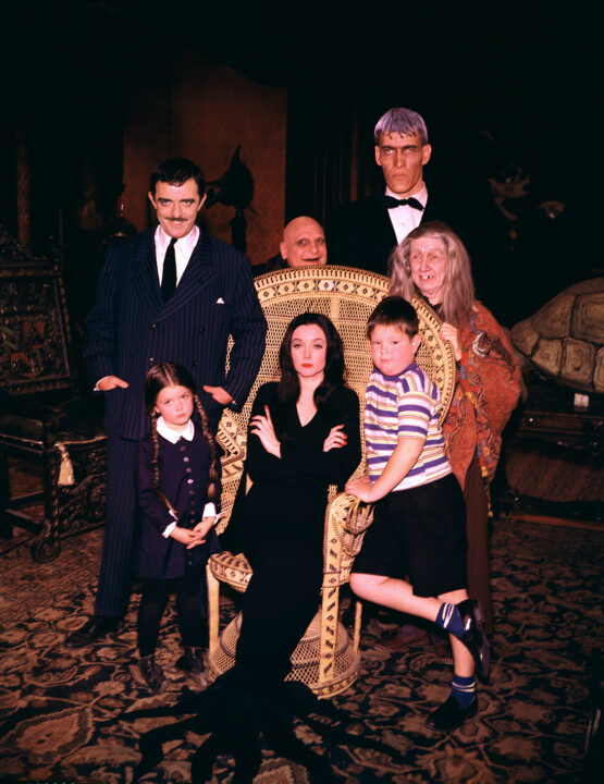 THE ADDAMS FAMILY, (front row) Lisa Loring, Carolyn Jones (seated), Ken Weatherwax, (back row) John Astin, Jackie Coogan (behind chair), Ted Cassidy, Blossom Rock, 1964-66.